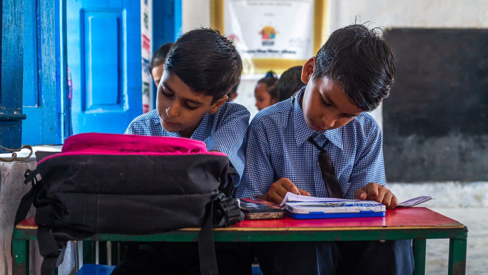 Indian school students concentrating on their written work